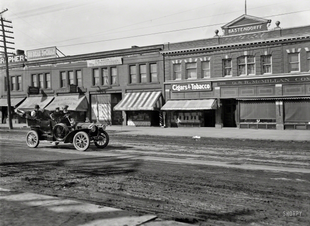 Photo showing: And Step on It! -- Detroit circa 1910. Bastendorff block and G. & R. McMillan Co. store, Jefferson Avenue.
