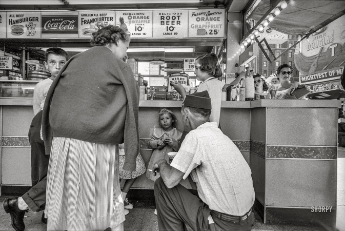 Photo showing: Delicious Root Beer -- New York City. 1958. People gathered at lunch counter.