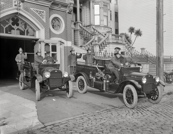 Photo showing: One and Two -- San Francisco, 1921. Sonora Fire Dept. REO trucks at Engine Company No. 15 firehouse, California Street.