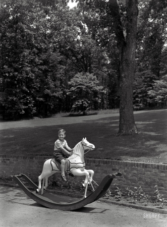 Photo showing: Upperville: 1947 -- June 17, 1947. Paul Mellon residence in Upperville, Virginia. Timmie on hobbyhorse.