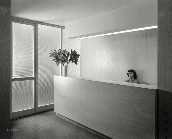 Photo showing: Modern Receptionist -- Oct. 27, 1948. Russel Wright, 221 E. 48th St., New York City. Office with secretary.