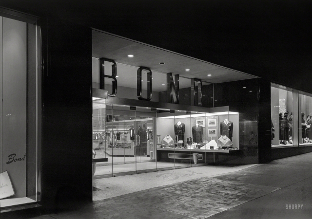 Photo showing: Trick or Treat -- Oct. 31, 1948. Bond's, New York City. Night exterior, Fifth Avenue.