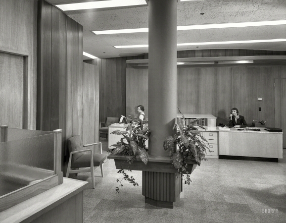 Photo showing: Desk-Set -- January 25, 1955. Becton Dickinson Inc., Rutherford, New Jersey. Entrance toward double secretarial desk.