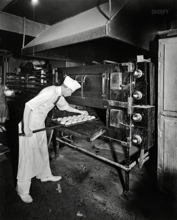 Photo showing: Buns in the Oven -- Montgomery County, Md., circa 1950. Potomac Electric Power Co. --
Commercial kitchens, restaurants and lighting. Takoma Park Bakery.