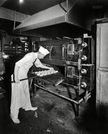 Photo showing: Buns in the Oven -- Montgomery County, Md., circa 1950. Potomac Electric Power Co. --
Commercial kitchens, restaurants and lighting. Takoma Park Bakery.