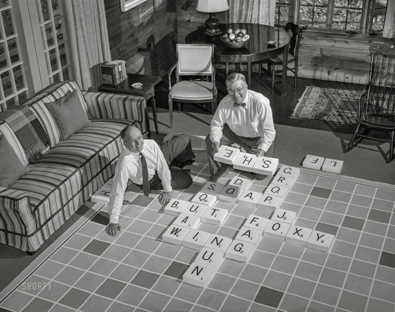 Photo showing: Very Big Words -- November 1953. Scrabble inventor Alfred Butts & promoter James Brunot posed with oversized game.