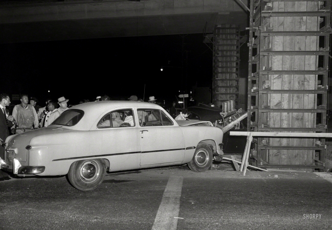 Photo showing: Expect Delays -- Oakland or thereabouts circa 1957, and two cars that have just taken out a stoplight.