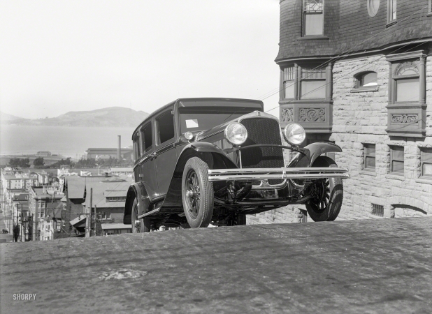 Photo showing: Vroom With a View -- San Francisco circa 1928. DeSoto sedan cresting hill on Webster Street.