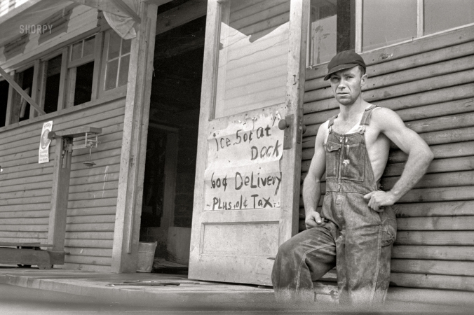 Photo showing: The Iceman -- August 1935. Huntsville, Arkansas. Farmer who supplements his income by selling ice.