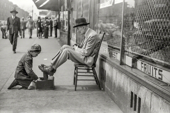 Photo showing: Taking a Shine -- April 1941. Shoeshine, 47th Street, Chicago's main Negro business street.
