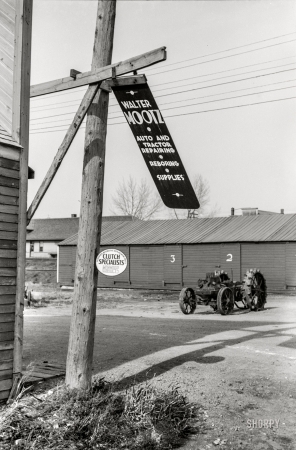 Photo showing: Tractor Doctor -- October 1940. Metal sign blowing in the wind. Doyon, North Dakota.