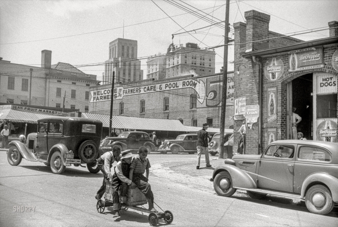 Photo showing: Box Car -- May 1940. Outside of the tobacco warehouses in Durham, North Carolina.