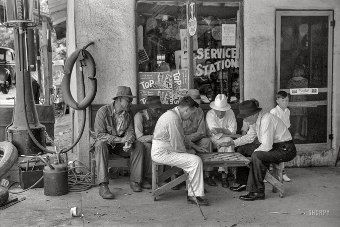 Photo showing: Your Move -- June 1939. Greensboro, Greene County, Georgia. Playing checkers outside a service station on a Saturday afternoon.