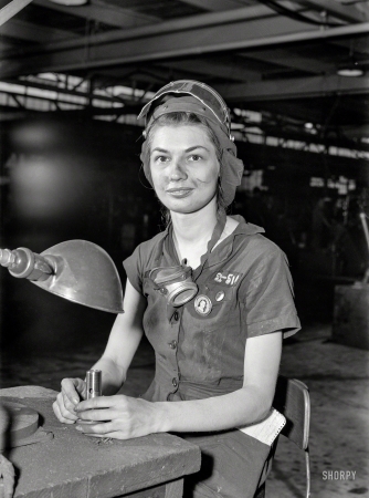 Photo showing: Eunice the Grinder -- August 1942. 21-year-old Eunice Hancock, erstwhile five-and-ten-cent store
employee, operates a compressed-air grinder in a Midwest aircraft motor plant.