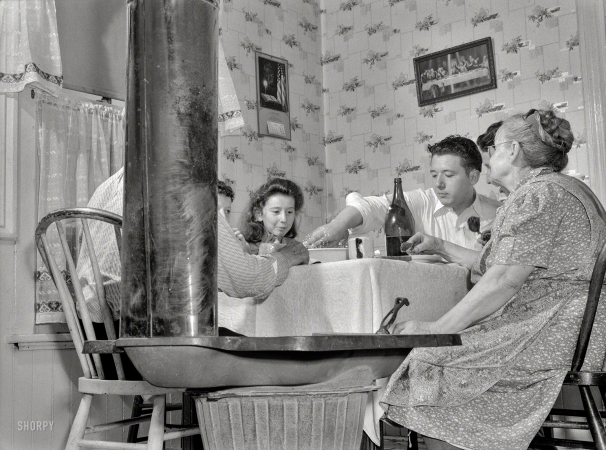 Photo showing: Made in America. -- June 1942. Manpower. Americans all. His war job with
Pressed Steel Car Co. gives Michael Kassalo an extra good appetite ... 