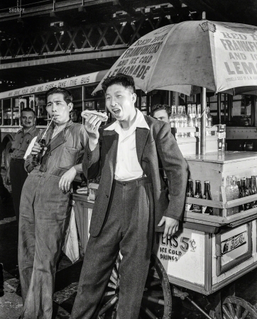 Photo showing: With Relish -- September 1942. New York City. First Chinese seamen granted shore leave in wartime
America. Lee Ah Ding (left) and Yee Chee Ching, Chinese seamen from a British freighter. 