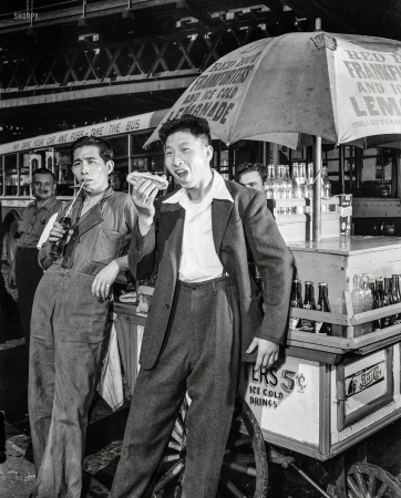 Photo showing: With Relish -- September 1942. New York City. First Chinese seamen granted shore leave in wartime
America. Lee Ah Ding (left) and Yee Chee Ching, Chinese seamen from a British freighter. 