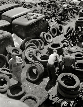 Photo showing: War Scrap -- July 1942. Chicago automobile graveyard holds tons of vital scrap metal and rubber for which Uncle Sam has urgent need ... 
