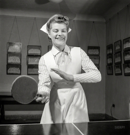 Photo showing: This Wont Hurt a Bit -- November 1942. Babies' Hospital, New York. At the ping-pong table in the game room,
Susan Petty, student nurse, enjoys a bit of relaxation after a busy day's work in the wards.