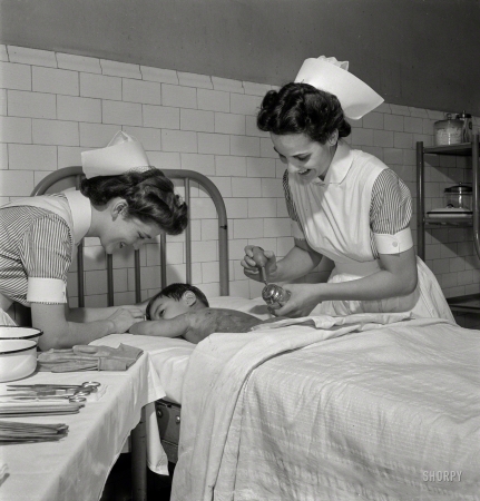 Photo showing: Spritzed by an Angel -- November 1942. Babies' Hospital, New York. Nurse paints a boy's burned back with sulfathiazole.
