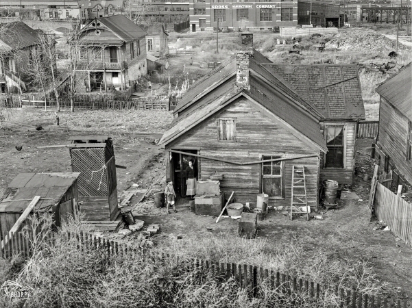 Photo showing: The Wrong Side -- November 1938. Houses along the railroad tracks. Omaha, Nebraska.