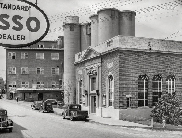 Photo showing: Rolling in Dough -- Spring 1940. Bank and flour mill elevators in Mount Airy, Maryland.