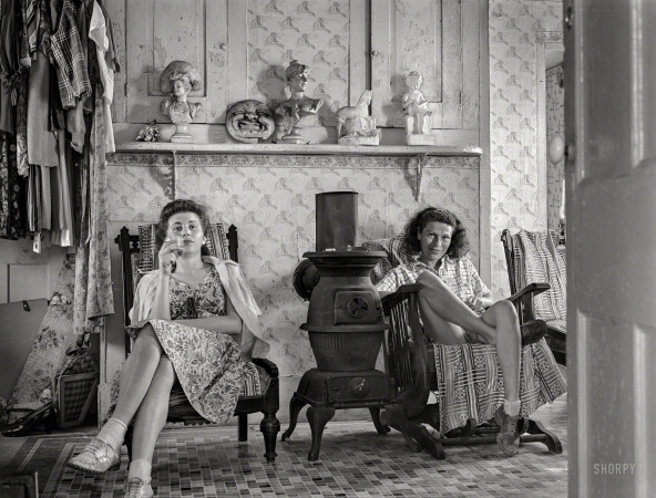 Photo showing: The Cocktail Hour. -- August 1940. Truro, Massachusetts. Guests in bedroom of tourist house having a glass of whisky.