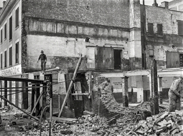 Photo showing: Condemned. -- December 1941. New York. Workmen wrecking condemned buildings
in the demolition of a slum area to make room for a housing project.