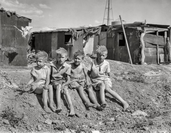 Photo showing: Hovel-Ready -- May 1937. Children of migrant cotton field workers from Sweetwater, Oklahoma.
Eight children in the family. Note the housing. Near Casa Grande project, Arizona.