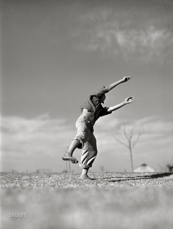 Photo showing: Flyboy II -- January 1942. Flying model airplane. Farm Security Administration camp at Robstown, Texas.