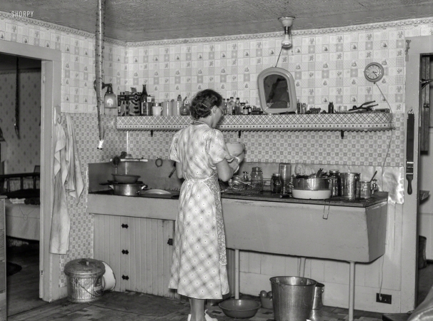 Photo showing: Stuck in the Kitchen -- September 1937. Hired girl washing dishes on the McNally farm. Kirby, Vermont.