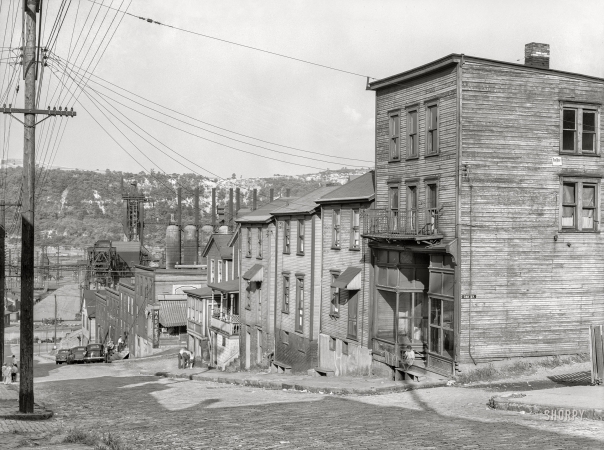 Photo showing: Oak Alley -- July 1938. Workers' homes with steel plant along Monongahela River in background. Duquesne, Pennsylvania.