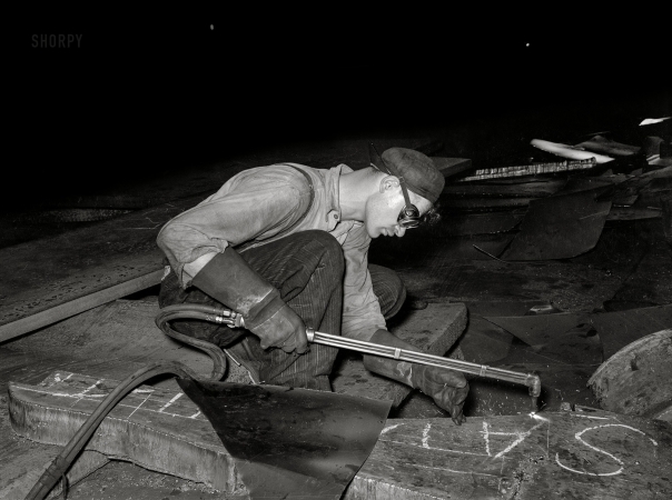 Photo showing: - Man of Steel - -- July 1938. Steel worker at rolling mill. Pittsburgh, Pennsylvania.