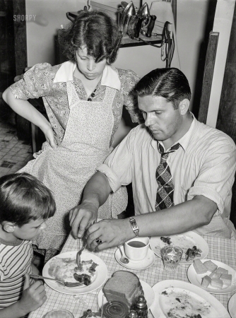 Photo showing: Dinnertime Dad -- July 1938. Aliquippa, Pennsylvania. The Clifford Shorts family
at dinner. Mr. Shorts is a roller at the Jones & Laughlin steel mill.