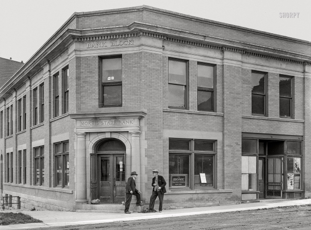 Photo showing: Bank Block -- June 1939. Morris State Bank, founded by Charles Morris during the boom days. Closed at present. Pony, Montana.