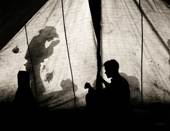 Photo showing: The Lonesome Cowboy -- June 1939. Shadows on tent, Quarter Circle U Ranch, Big Horn County, Montana.