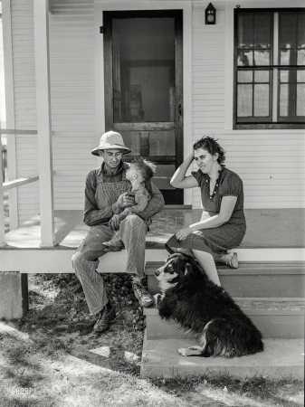 Photo showing: Dads Best Friend -- October 1939. Carl Higgins family, tenant purchase borrowers, on the porch of their farmstead in Mesa County, Colorado.
