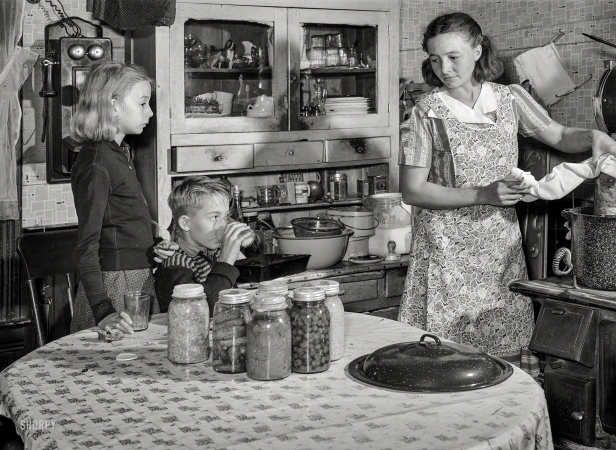 Photo showing: Farm to Table. -- November 1939. Mrs. John Dixon cans an adequate supply of fruits and vegetables
to give her family a balanced diet during the winter. Saint Charles County, Missouri.