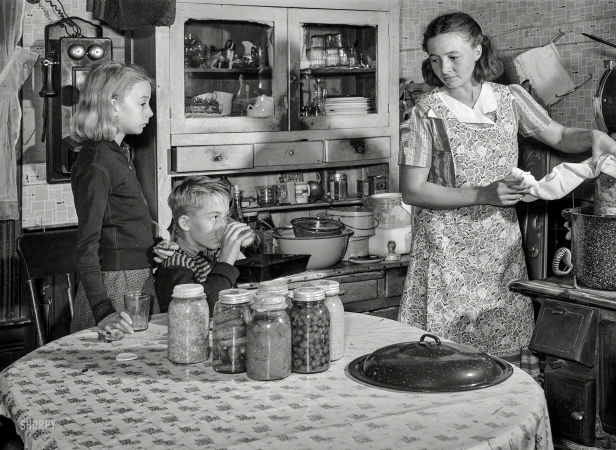 Photo showing: Farm to Table. -- November 1939. Mrs. John Dixon cans an adequate supply of fruits and vegetables
to give her family a balanced diet during the winter. Saint Charles County, Missouri.