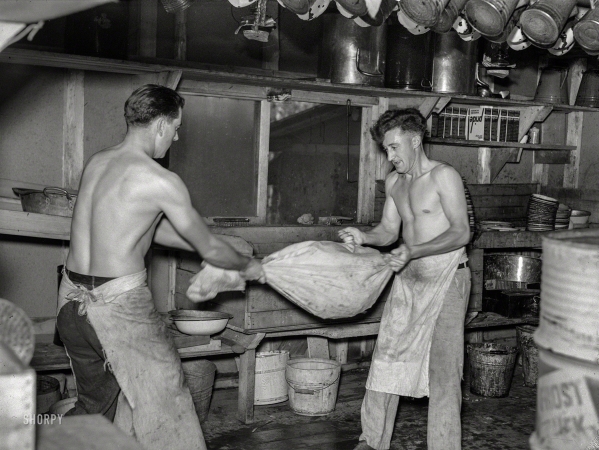 Photo showing: The Lumberjack Way -- September 1937. Cooks drying 'silverware' in logging camp near Effie, Minnesota.