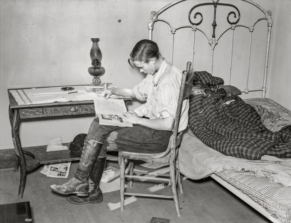 Photo showing: Fight It Out! -- October 1937. Boy reading in bedroom. Home of A.O. Ryland, near Williston, North Dakota.