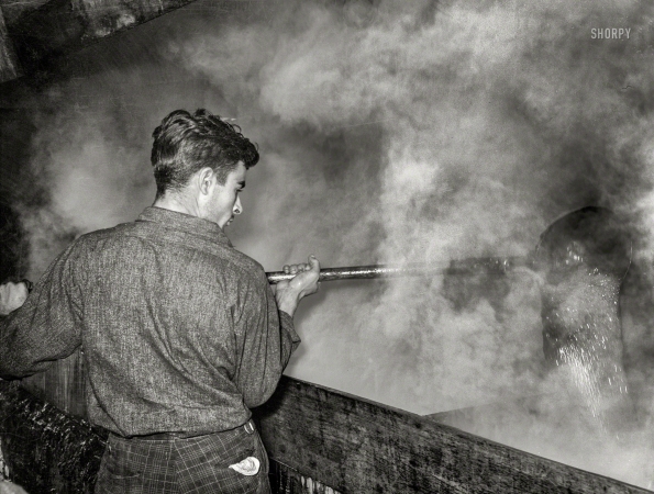 Photo showing: A Spoonful of Sugar -- October 1938. Ladling cane syrup from boiling vat to concentration vat at a sugar mill near New Iberia, Louisiana.