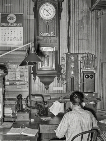 Photo showing: Santa Fe Time -- April 1939. Office of train dispatcher and Western Union. San Augustine, Texas.