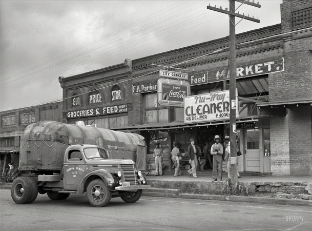 Photo showing: City Grocery -- April 1939. Wholesale truck in front of grocery store. San Augustine, Texas.