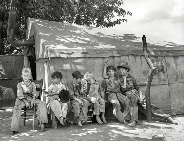 Photo showing: The Peanut Gallery -- June 1939. Sons of day laborers in tent camp near Webbers Falls, Oklahoma. None of these children had ever attended school.