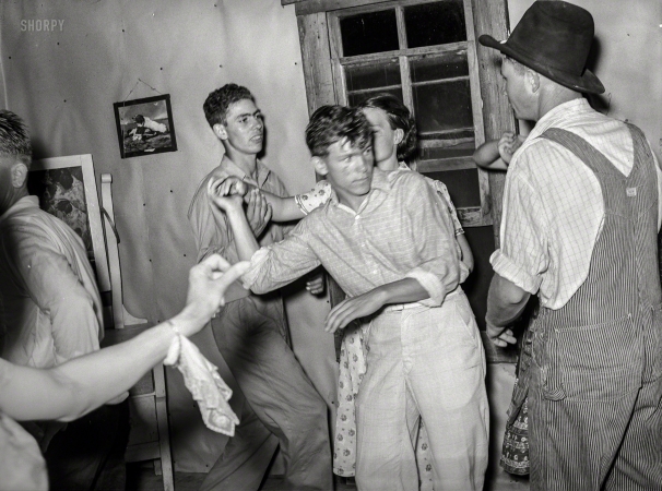 Photo showing: The Desperate Hours -- July 1939. Detail of square dance in hills near McAlester, Pittsburg County, Oklahoma. Sharecropper's home.