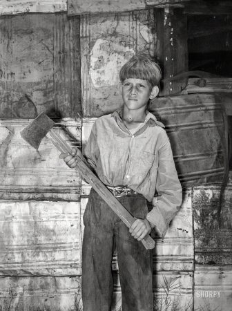 Photo showing: Dead Serious -- July 1939. Oklahoma City. Boy living in May Avenue camp with homemade ax.