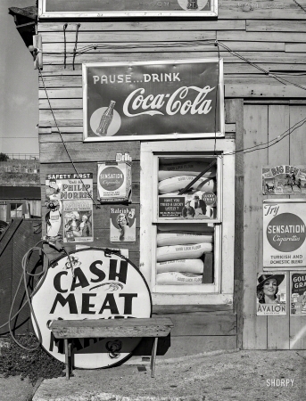 Photo showing: Name Your Poison. -- September 1939. Detail of front of combined filling station and grocery store. Questa, New Mexico.