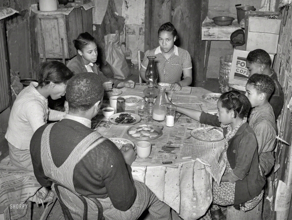 Photo showing: Farmhouse Kitchen -- February 1940. Family of tenant farmer Pomp Hall eating breakfast. Creek County, Oklahoma.