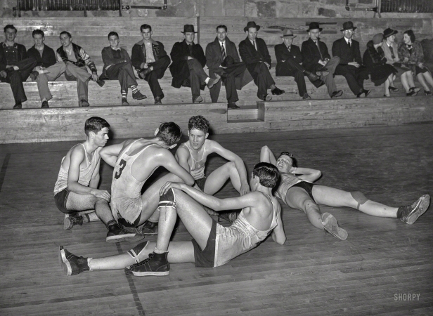 Photo showing: Take Five -- February 1940. Basketball players resting between periods. Eufaula, Oklahoma.